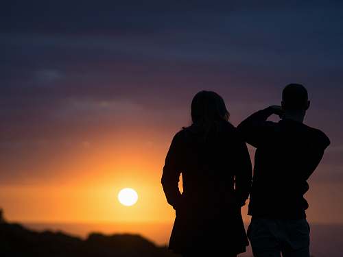 human man and woman silhouettes during golden hour people