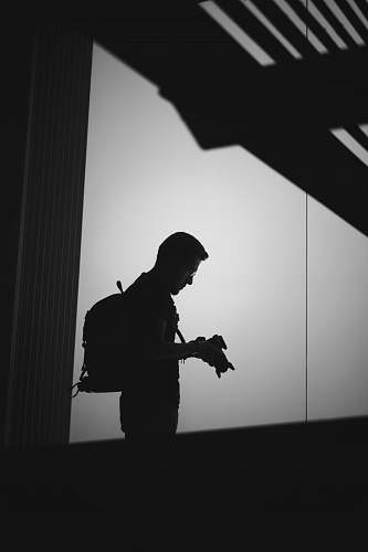 grey man holding camera black-and-white