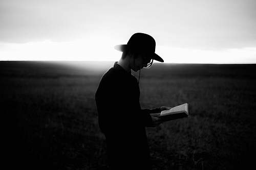 people man reading book black-and-white