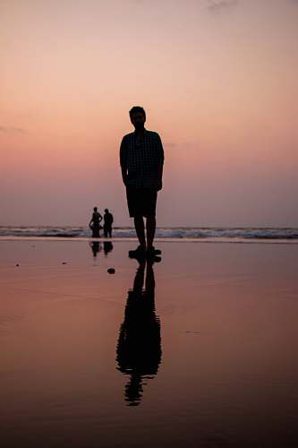 human man standing on body of water people