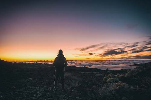 people man standing on top of mountain sky