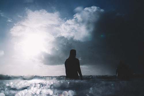 people person on body of water during daytime beach wallpapers