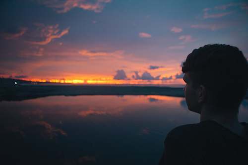 people person standing near sea under cloudy sky man