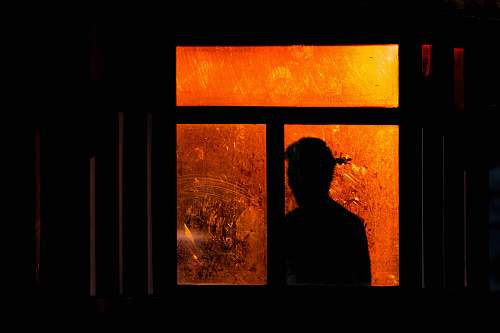 people silhouette of a person at the window human