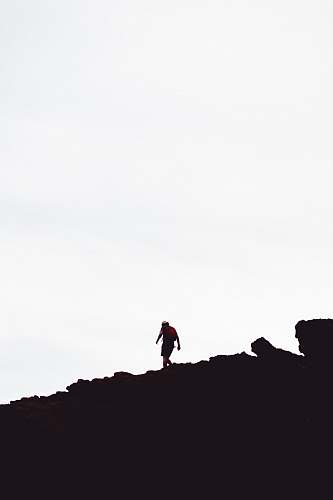 human silhouette of man on hill standing