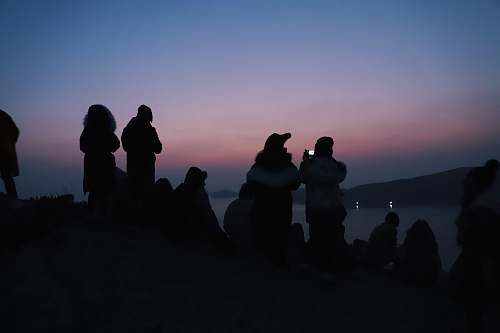 people silhouette of people near body of water human