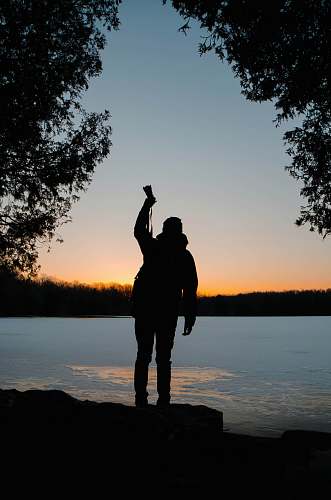 human silhouette of person raising his right hand people