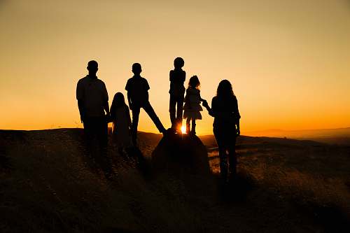silhouette silhouette photography of family during golden hour human