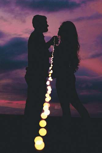 human silhouette photography of man and woman standing outdoors silhouette