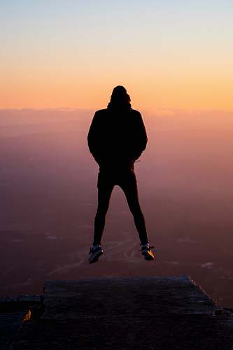 silhouette silhouette photography of person jumping human