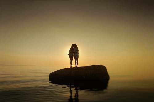 human two women on rock standing