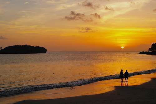 ocean two person on beach during sunset water