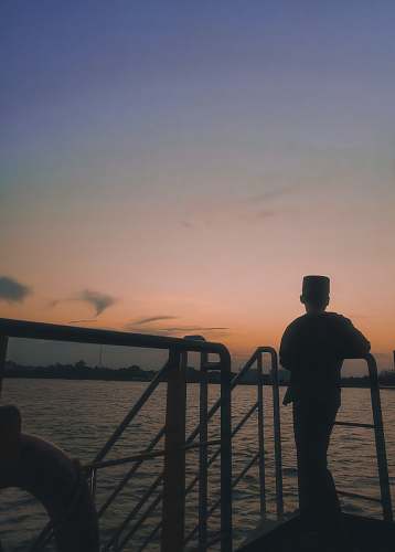 railing boy standing on the boat human