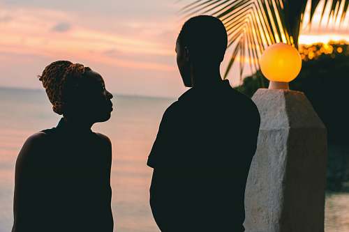 human couple standing beside body of water person