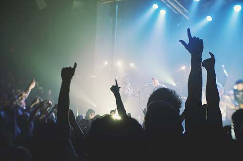 concert crowd cheering band during night time music