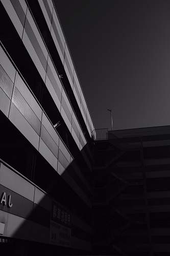 black-and-white grayscale photography of buildings with sun shadow matsuyama