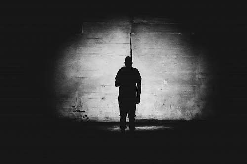 human grayscale photography of person standing black-and-white