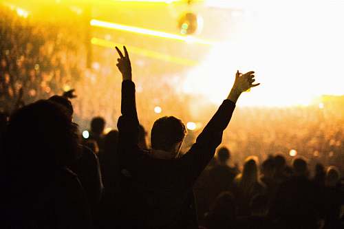 crowd group of people gathering in a indoor colliseum concert