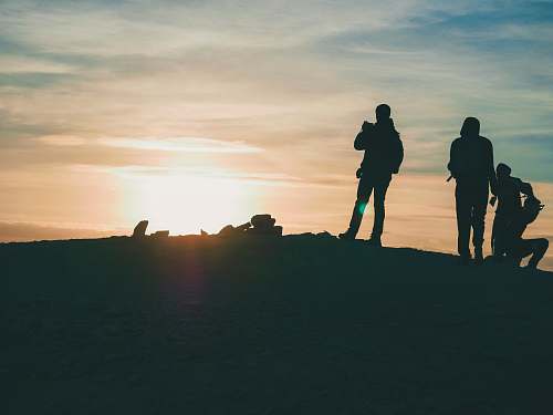 human group of people standing atop of mountain people