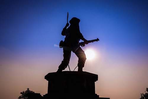 human man holding rifle statue person