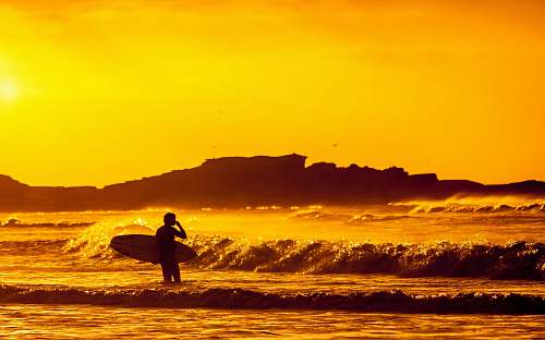 ocean man holding white surfboard surfer