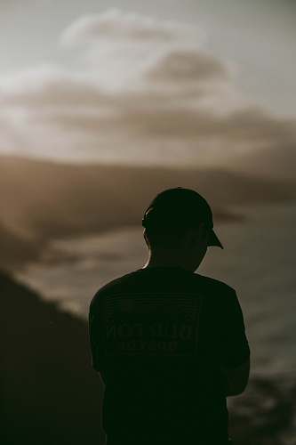 apparel man in Burton shirt facing ocean clothing