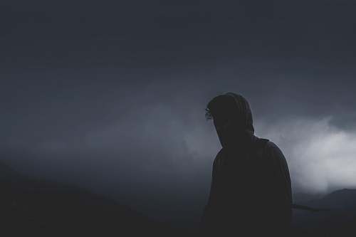 person man looking forward on cloudy path grey