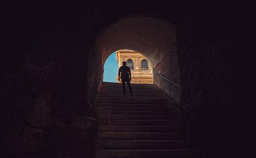 stairwell man standing on stairs arch