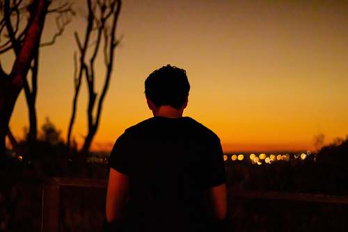 human man standing outside during golden hour person