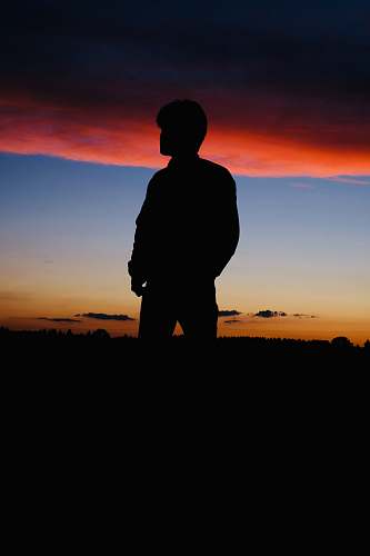 nature man standing under golden hour silhouette outdoors