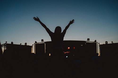 flare people at the concert during golden hour light