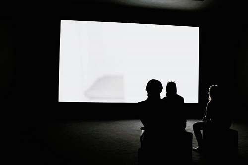 black-and-white people looking on projection screen white
