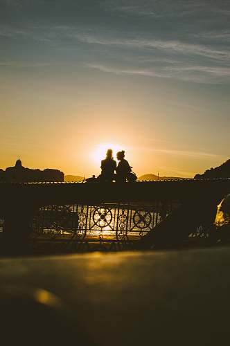 human people sitting on railing person