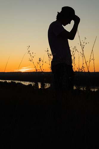 person person standing beside plants silhouette human