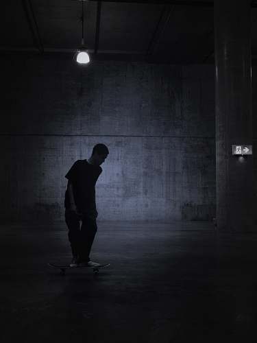 lighting person standing in room grey