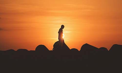 asilah person standing on rock platform morocco