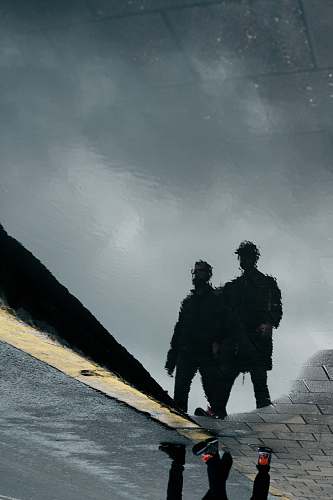 human reflection silhouette of two men on water person
