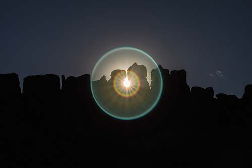 flare scenery of silhouette of rock formation rock