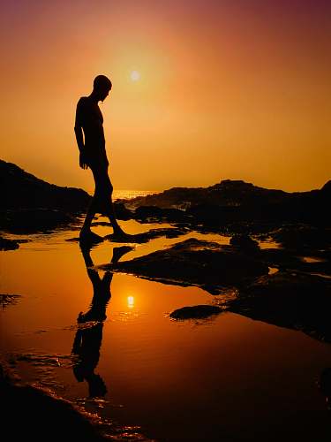 flare silhouette of a man at sunset light