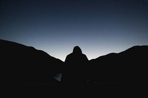 night silhouette of a person facing sunrise black