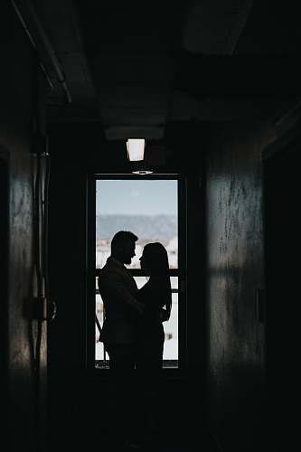 grey silhouette of couple inside dark room couple