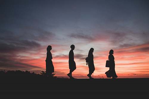 human silhouette of four person walking on ground people