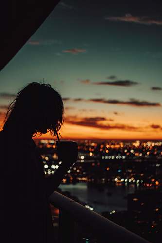 human silhouette of man holding mug during golden hour person