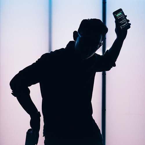 black silhouette of man holding smartphone dallas