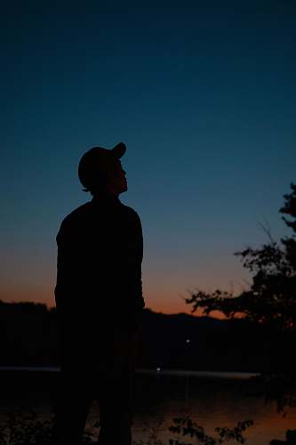 apparel silhouette of man looking at the sky clothing