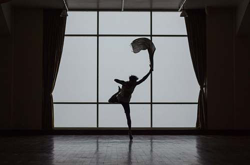 grey silhouette of man standing beside window dance