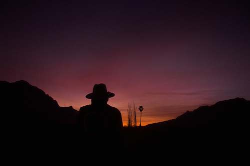 sky silhouette of man standing on mountain art
