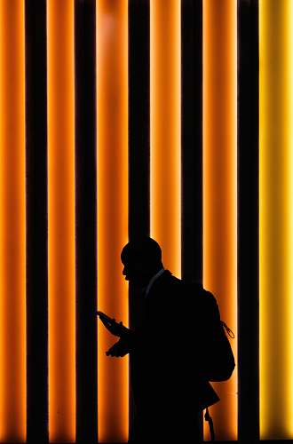 person silhouette of man standing on orange and black striped background human