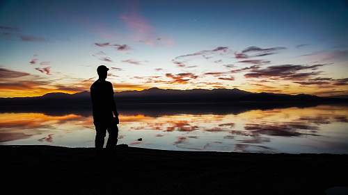 person silhouette of man standing on sand people