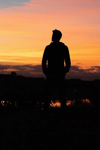 nature silhouette of man under yellow sky outdoors